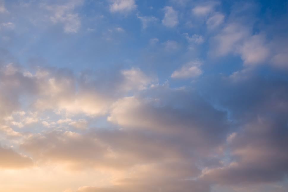 Free Image of Group of People Standing on Top of Beach Under Cloudy Sky 