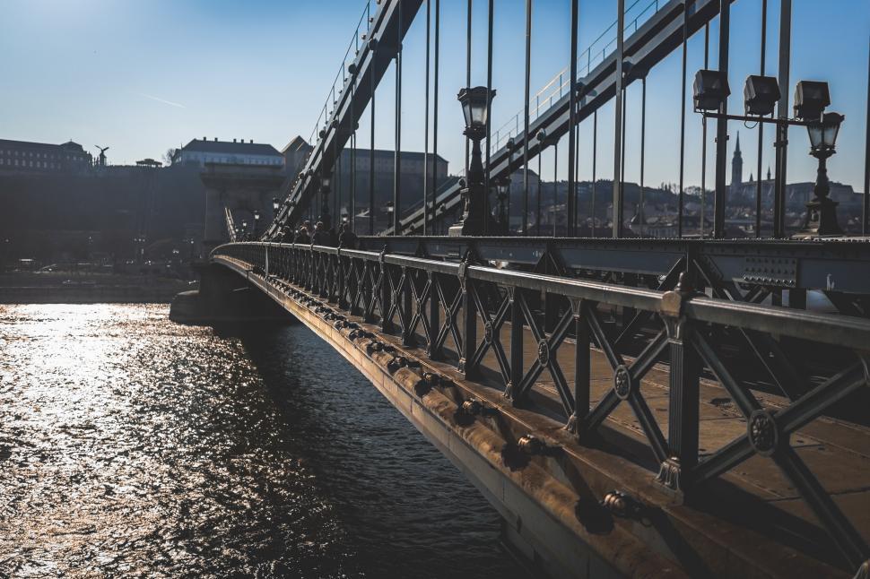 Free Image of Bridge Over Water With Buildings in Background 
