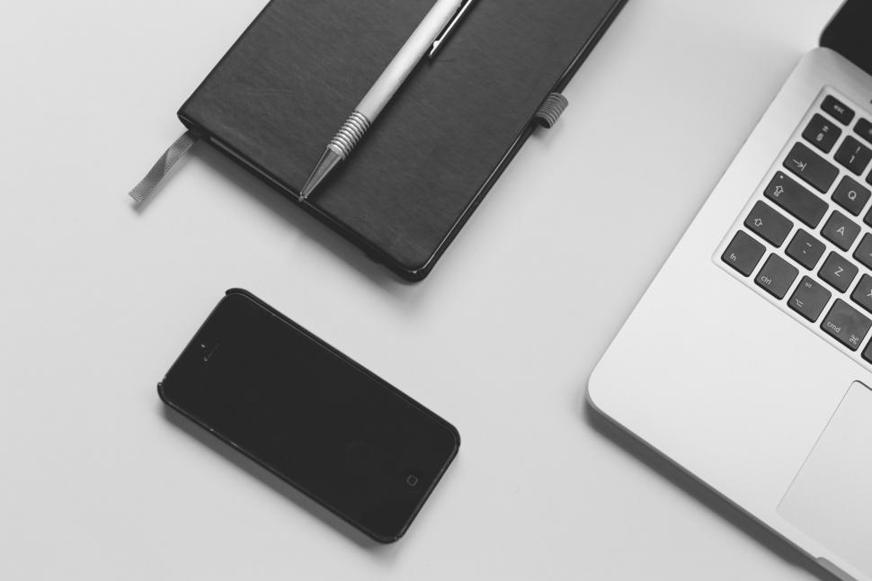 Free Image of Laptop Computer and Cell Phone Side by Side 