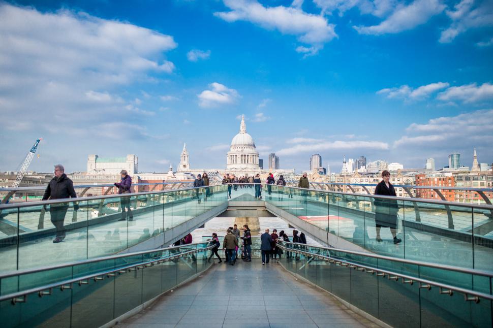 Free Image of Group of People Walking Across a Bridge 