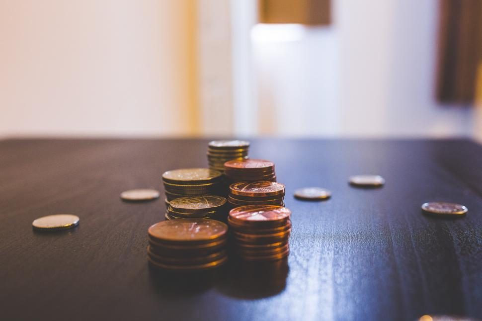 Free Image of Heap of Coins on Wooden Table 