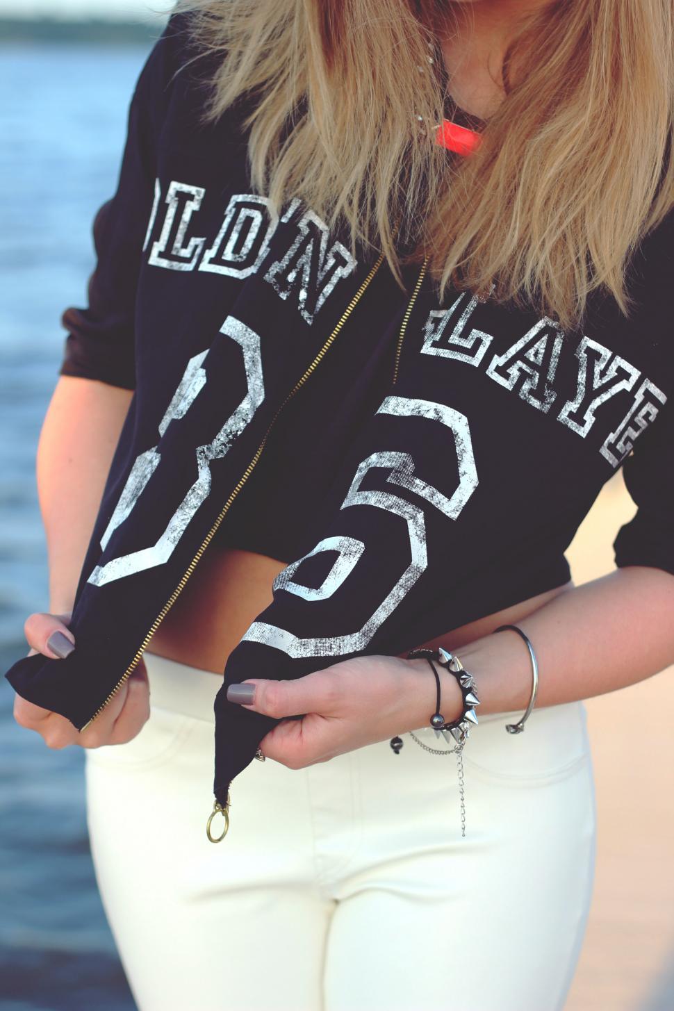 Free Image of Woman Wearing Black Shirt and White Pants 