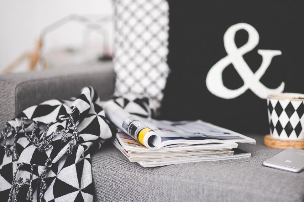 gray-couch-with-black-and-white-pillow-and-cup-of-coffee.jpg