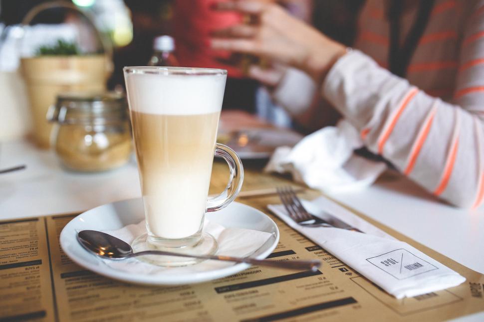 Free Image of Person Sitting at Table With Cup of Coffee 