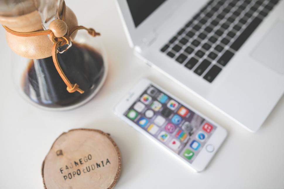 Free Image of Modern Workspace With Laptop, Cell Phone, and Wooden Slice 