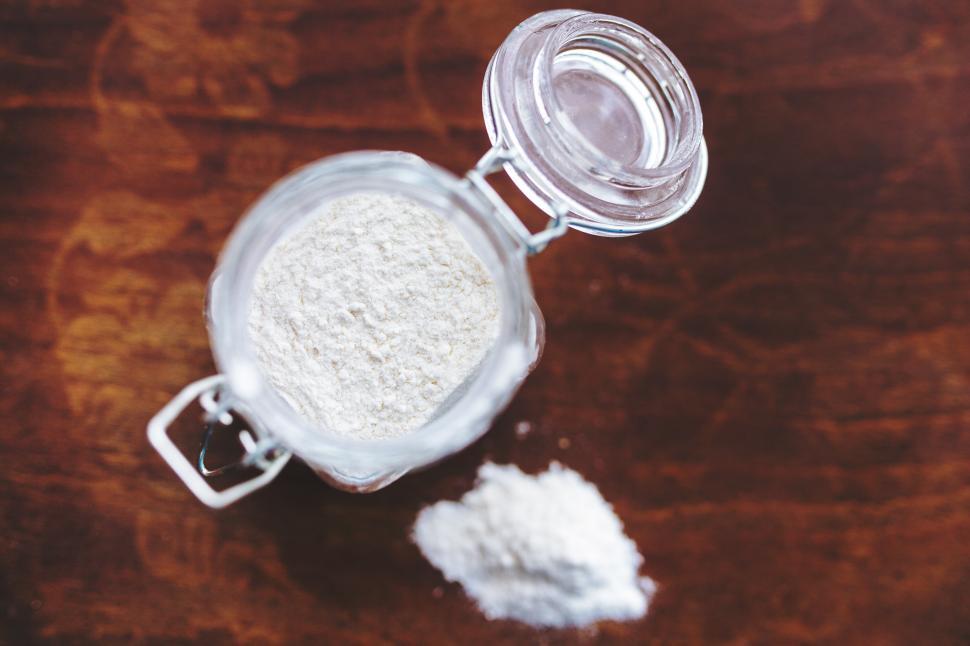Free Image of Glass Jar With White Powder on Wooden Table 