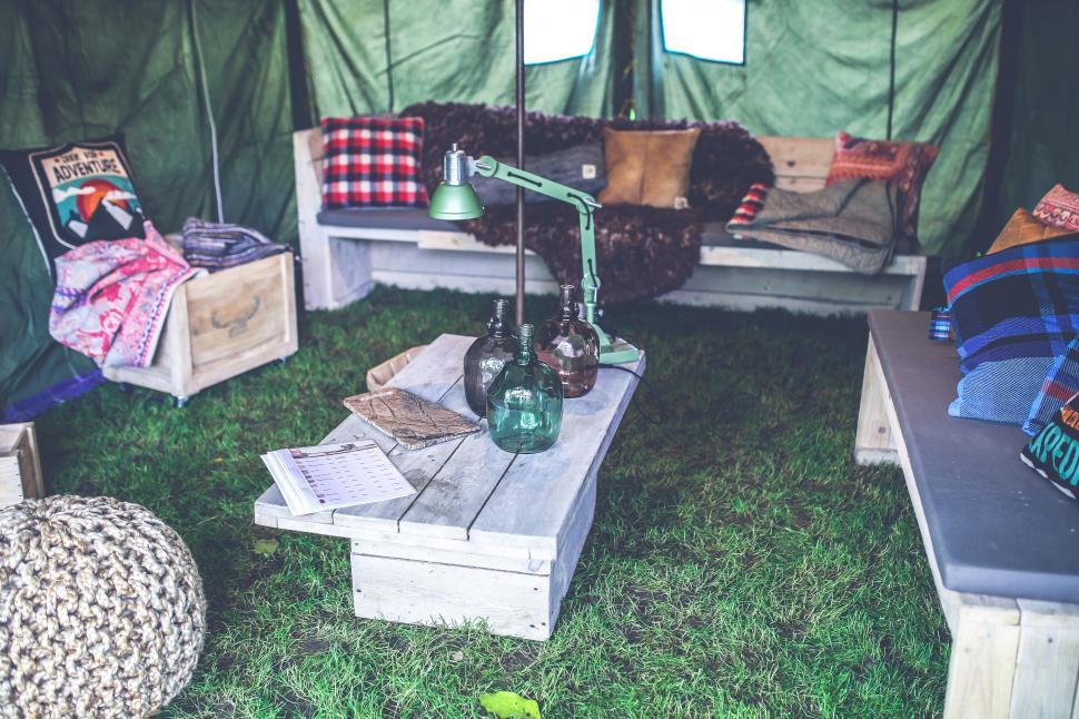 Free Image of Group of Couches and Tables in a Tent 