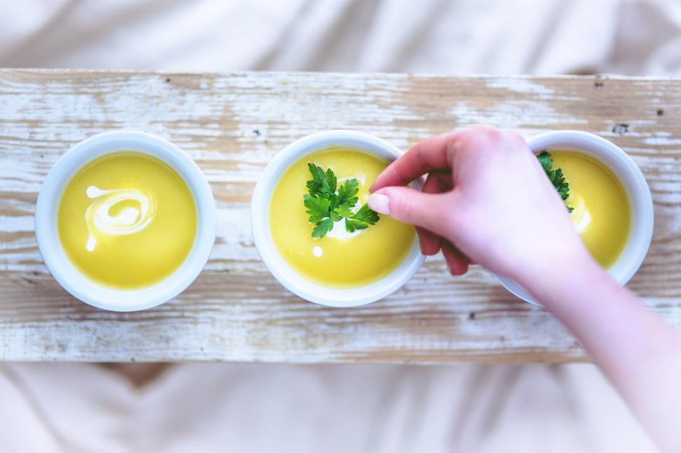 Free Image of Person Dipping Spoon Into Bowl of Soup 
