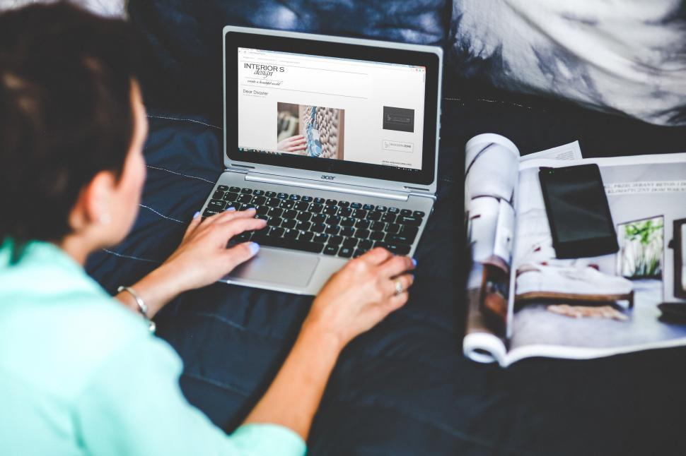 Free Image of Woman Sitting on Couch Using Laptop Computer 