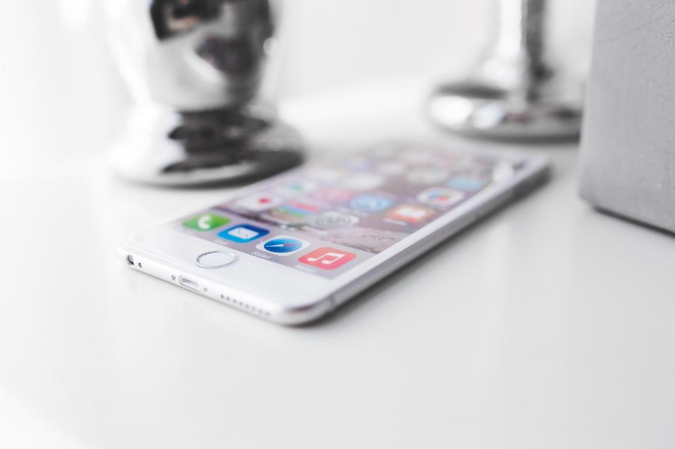 Stock Photo of Apple closeup device iphone iphone6 iphone6plus mobile mobilephone screen screentouch silver tech technology white control device technology keypad close phone business communication office control telephone