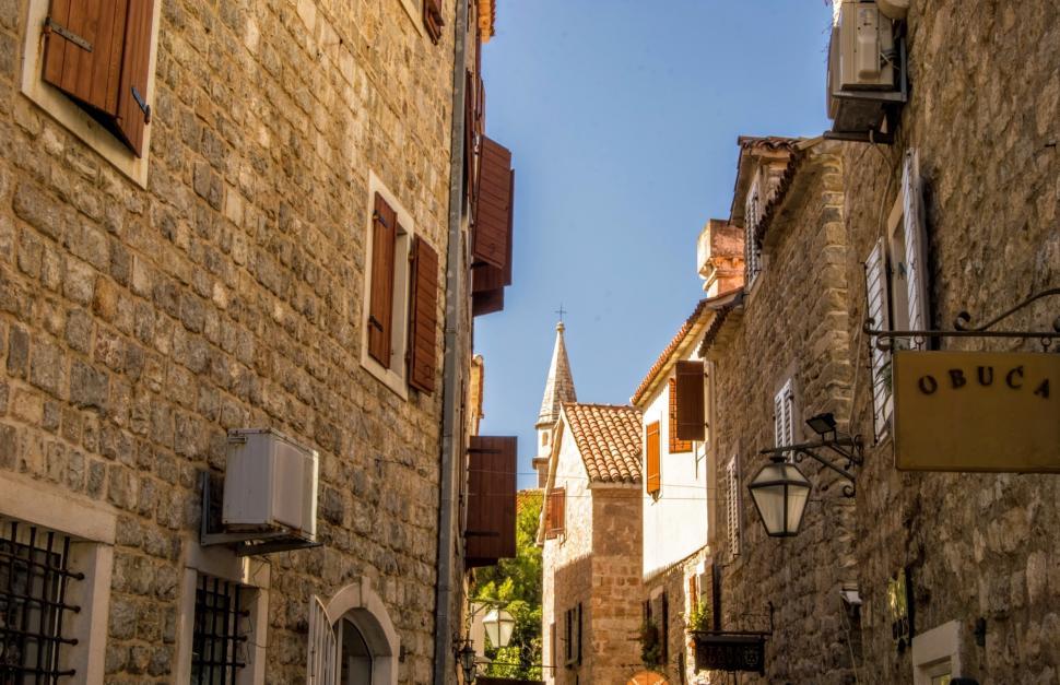 Free Image of Streets of the Old Town of Budva with a tower of the Catholic Church of Saint John Ivan in the background, Montenegro   