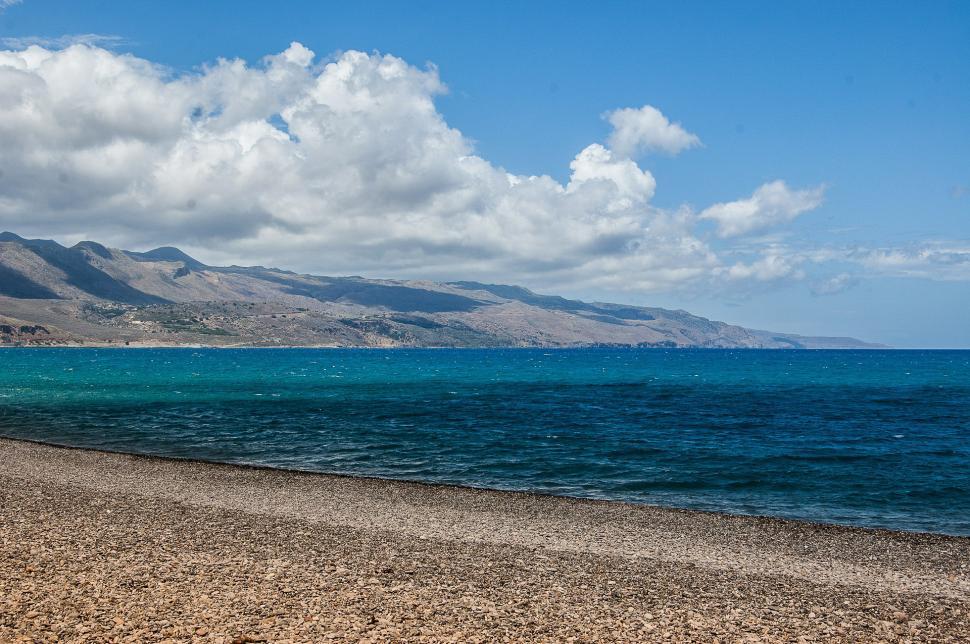 Free Image of Majestic Mountain Range Overlooking Body of Water 