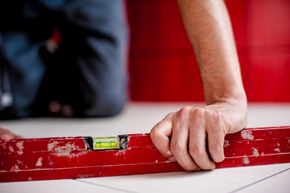Free Image of Person Holding a Piece of Red Tape 