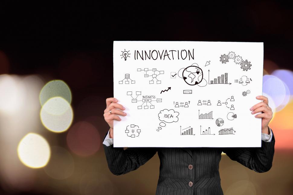 Free Image of Woman Holding Up Sign That Says Innovation 
