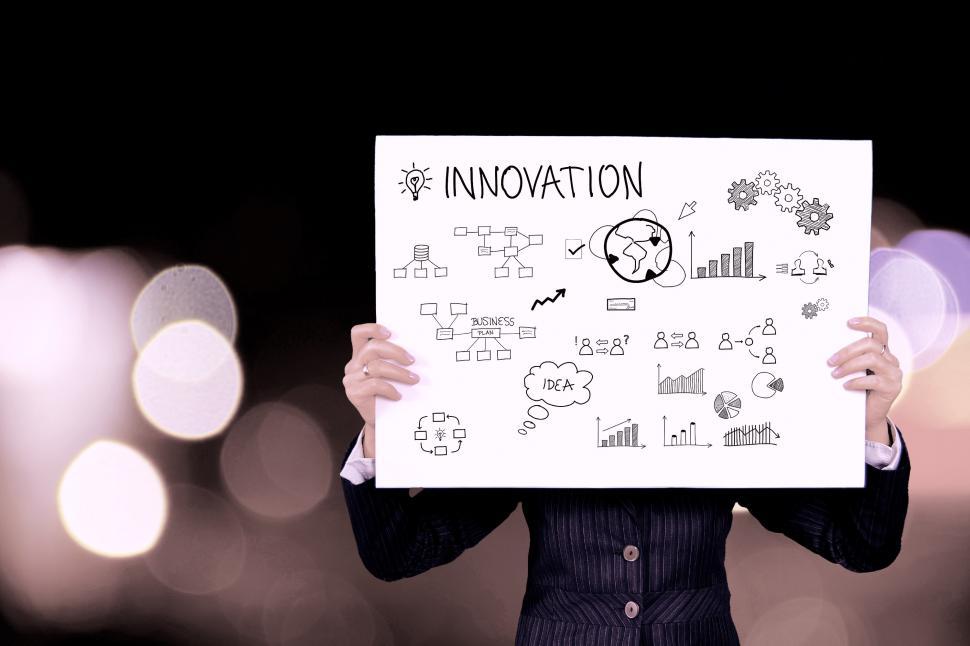Free Image of Woman Holding Up a Sign That Says Innovation 