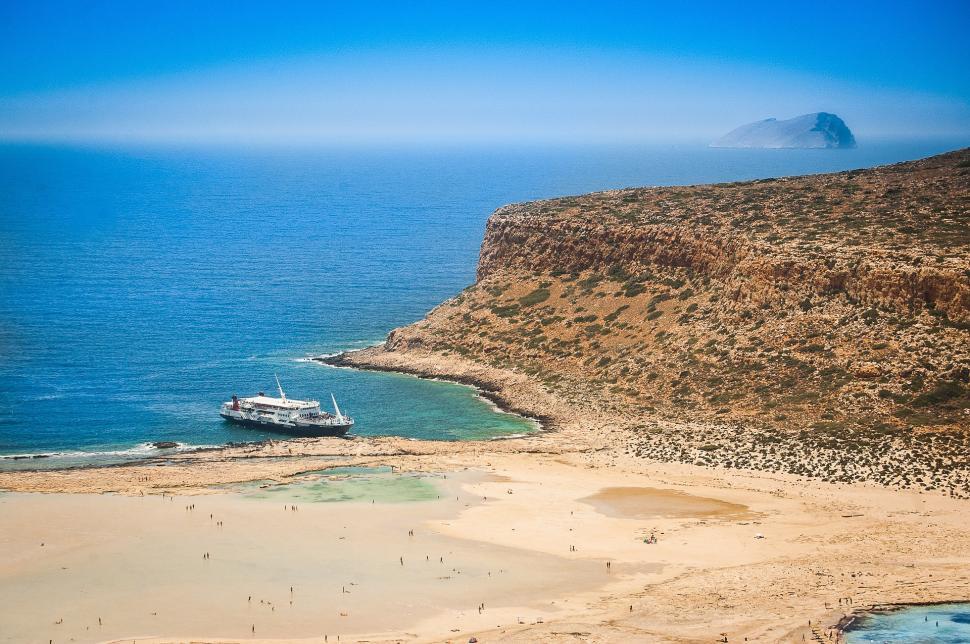 Free Image of Boat Sailing Near Beach Shoreline 