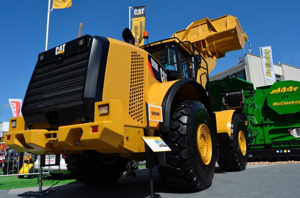 Free Image of Large Yellow Truck Parked Next to Green Truck 