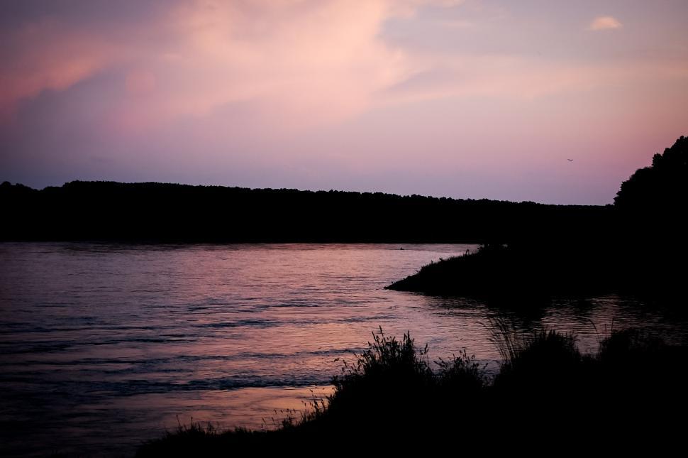 Free Image of Rippling Body of Water Under Cloudy Sky 
