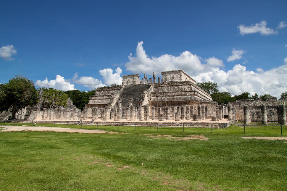 Free Image of Large Building in the Middle of a Lush Green Field 
