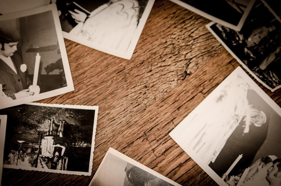 Free Image of Wooden Table With Photos of People 
