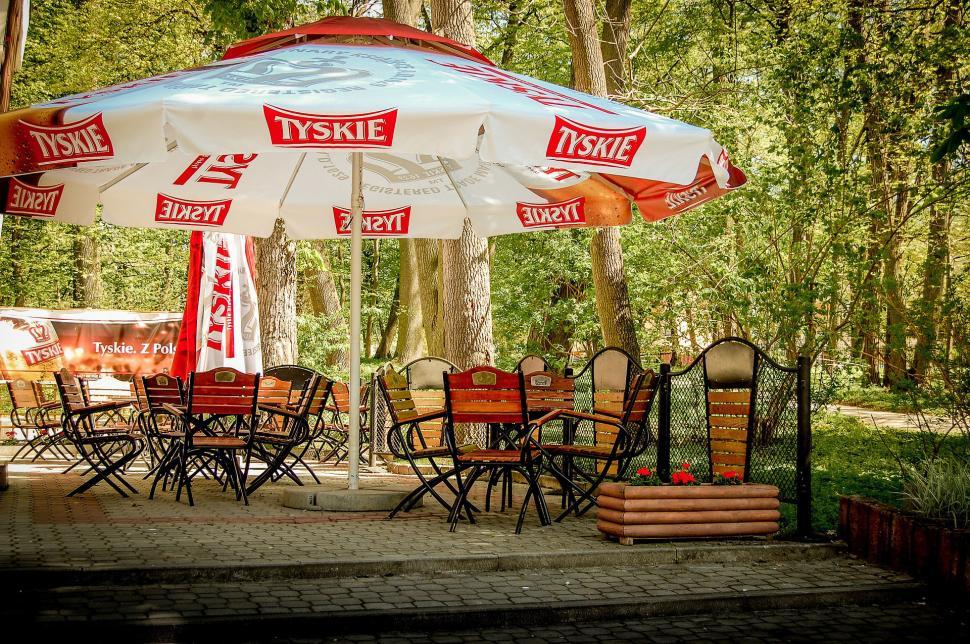 Free Image of Group of Tables and Chairs Under an Umbrella 