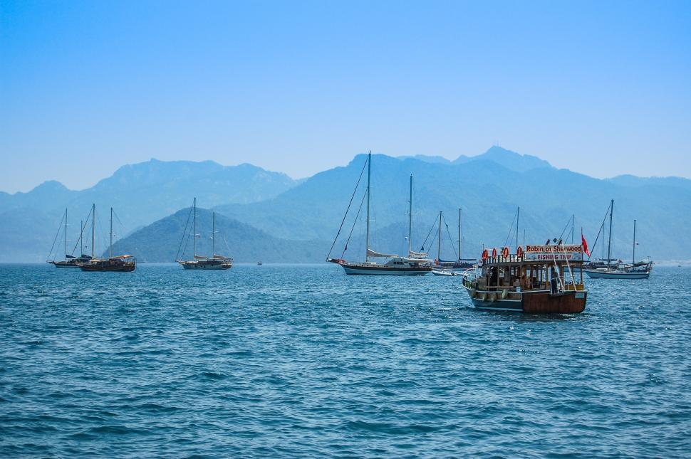 Free Image of Group of Boats Floating on Large Body of Water 