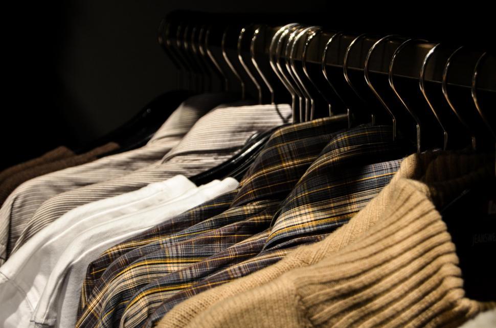 Free Image of Row of Clothes Hanging on a Rail 