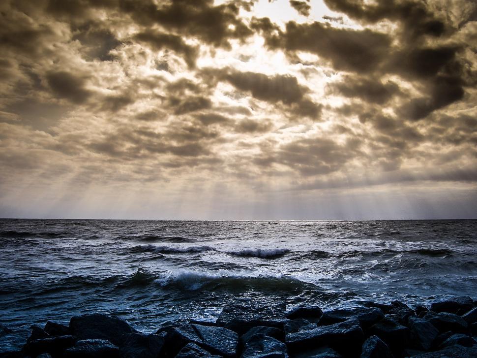 Free Image of Cloudy Sky Over Large Body of Water 