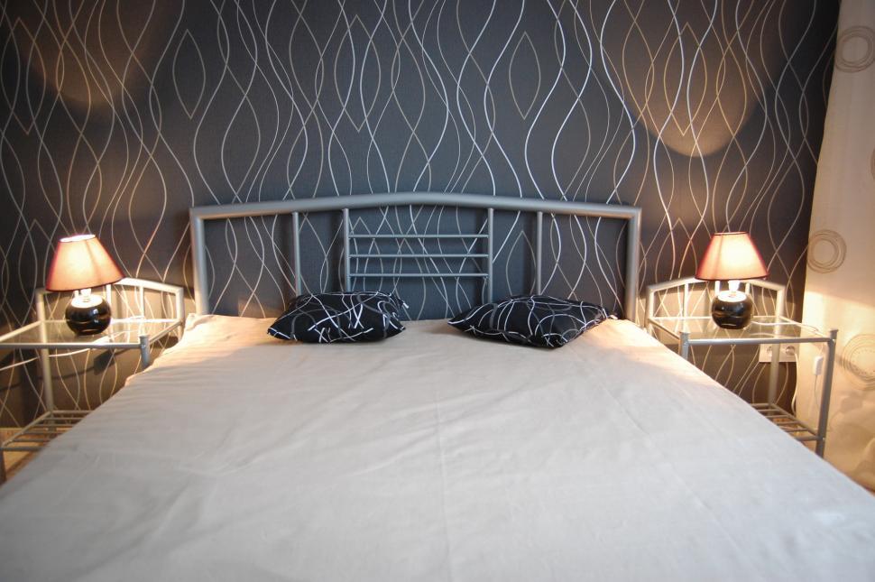 Free Image of Bed With Two Lamps on Either Side 