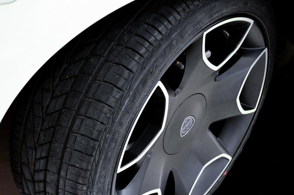 Free Image of Close Up of a Tire on a White Car 