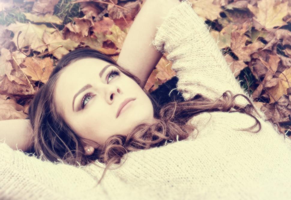 Free Image of Portrait of Dreamy Woman on Autumn Leaves 