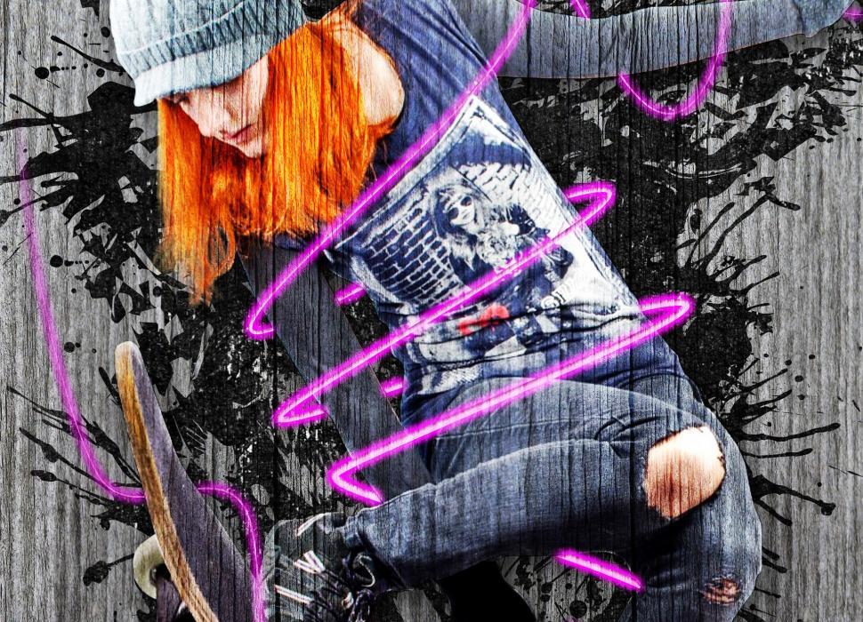 Free Image of Girl With Red Hair Performing Trick on Skateboard 