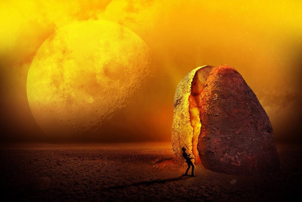 Free Image of Man Standing in Front of Large Rock 