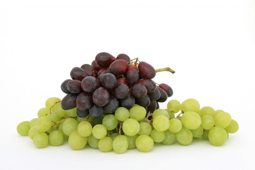 top view of ripe and organic grapes on green Stock Photo by