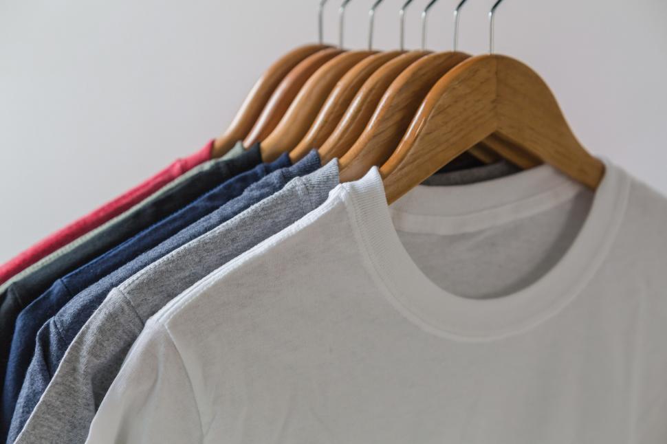 Free Stock Photo of Tshirts on wooden hangers