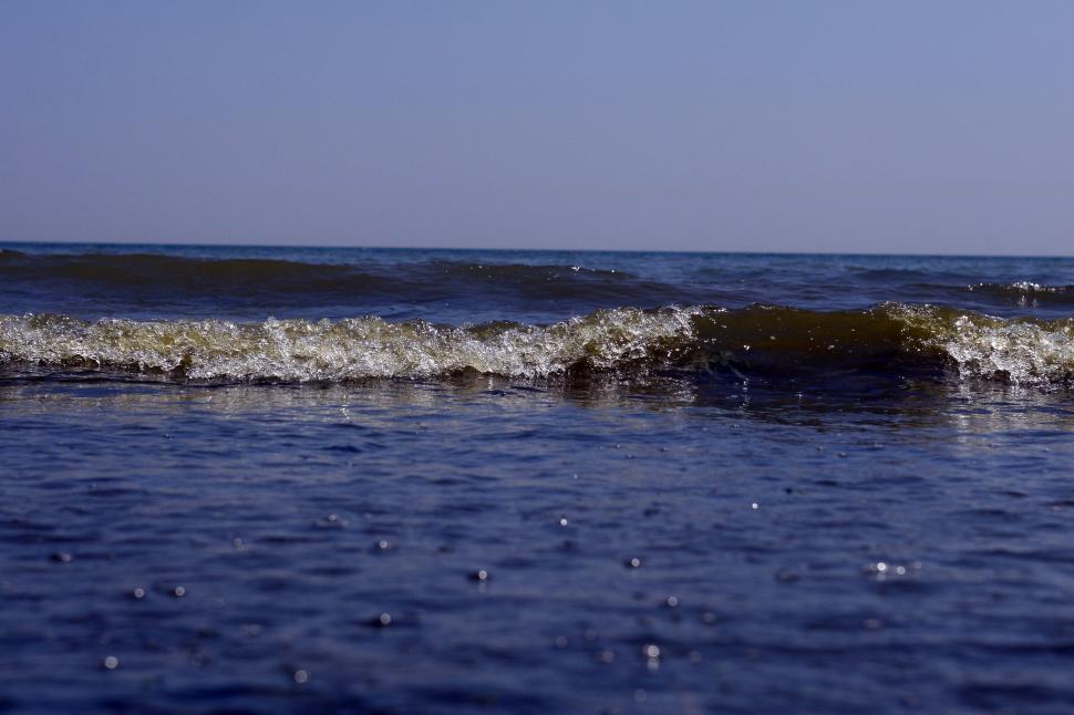 Free Image of Man Riding Wave on Surfboard 