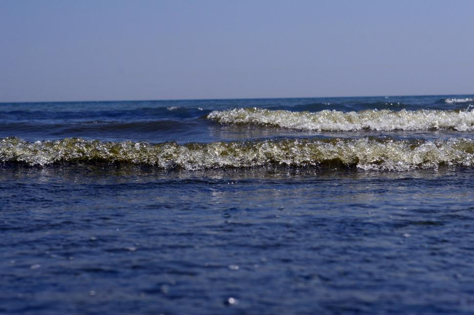 Free Image of Man Riding Wave on Surfboard 