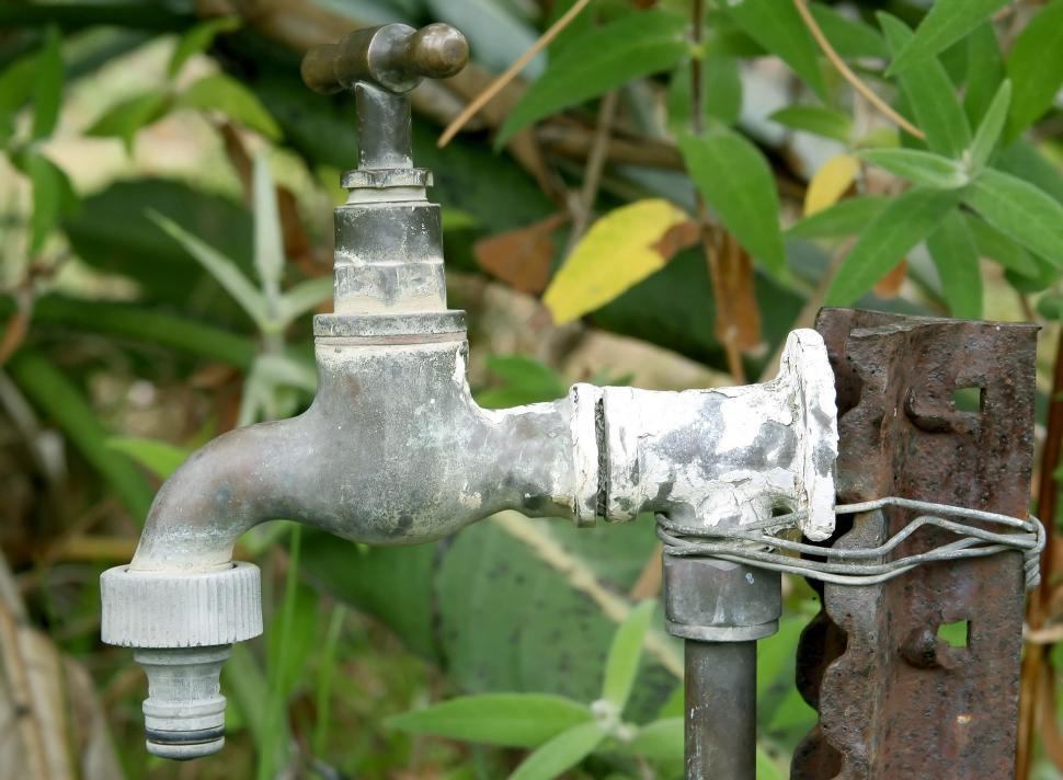 Free Image of Old Water Faucet Attached to Metal Pole 