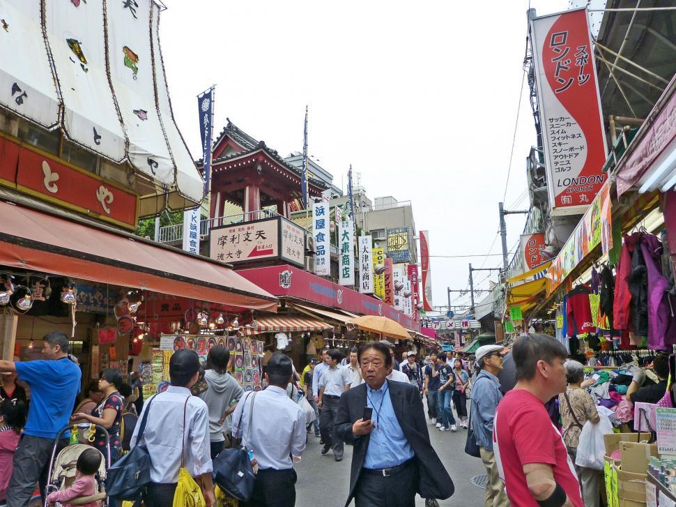 Free Image of Group of People Walking Down a Street 