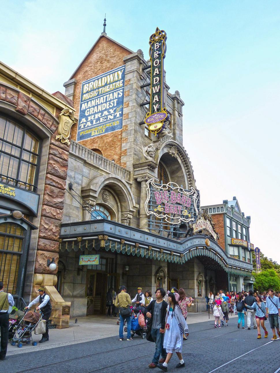 Free Image of Group of People Walking in Front of Theater 