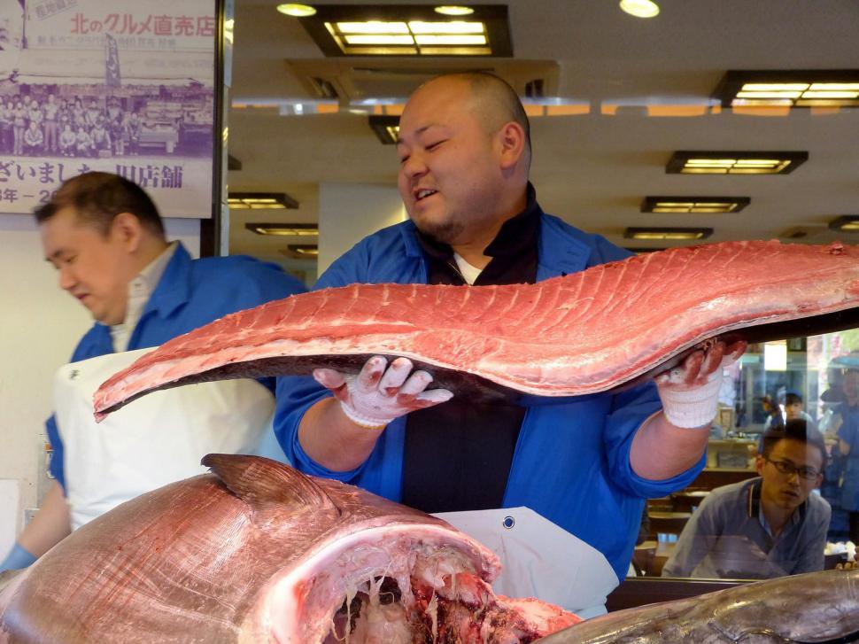 Free Image of Man Holding Large Piece of Meat 