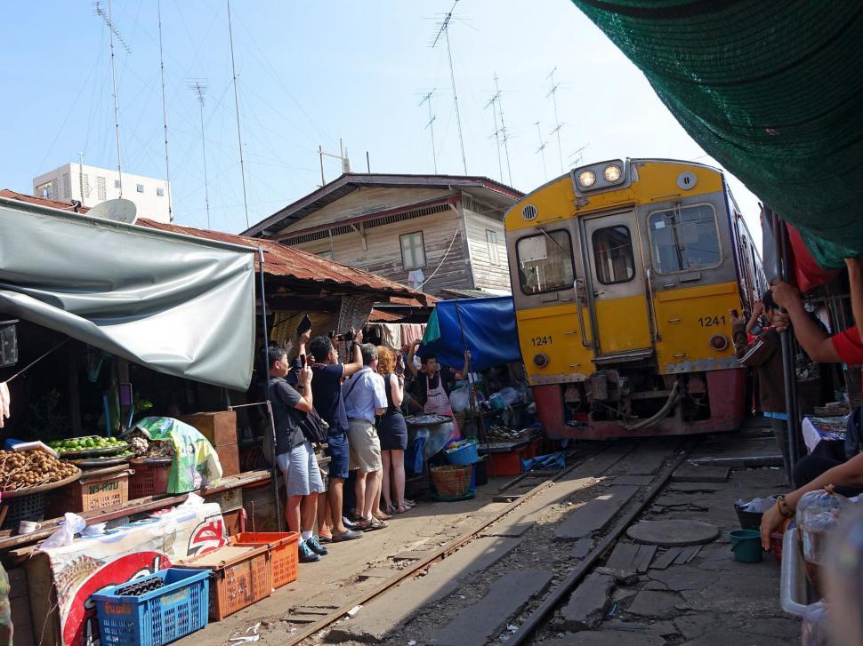 Free Image of Group of People Standing Outside Train Station 