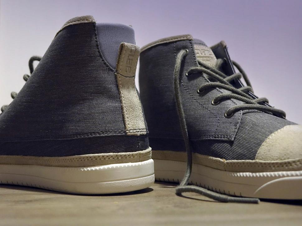 Free Image of Black and White Shoes on Wooden Floor 