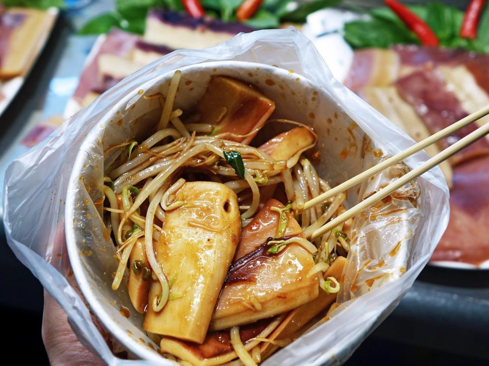 Free Image of Person Holding Bowl of Food With Chopsticks 