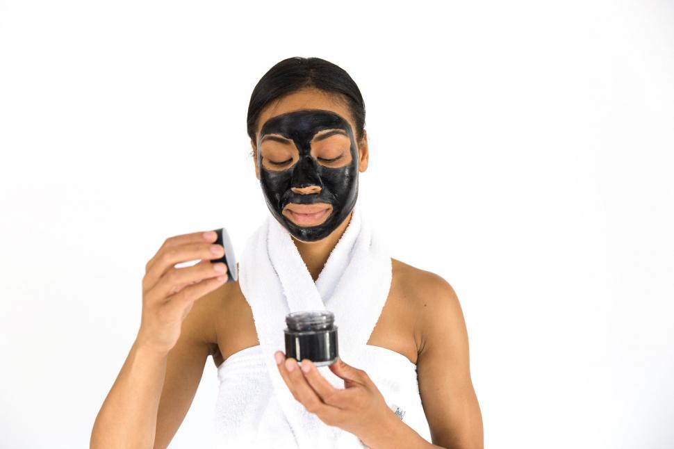 Free Image of Woman Opening Cosmetic Jar 