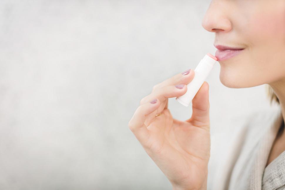Free Image of Woman Using Pale Lip Balm 