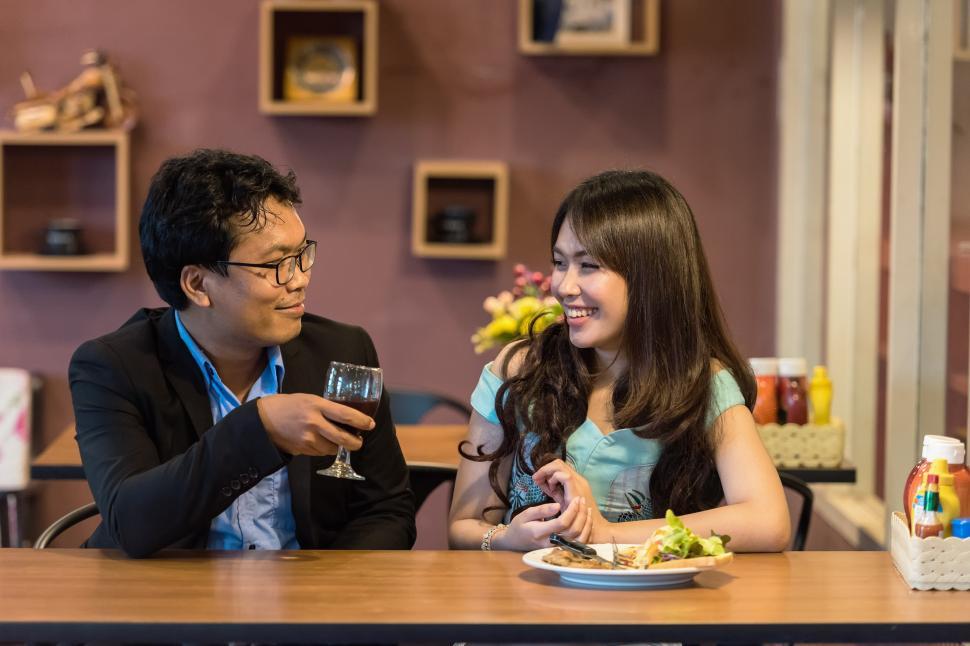 Free Image of Man and Woman Dining at Table With Plate of Food 