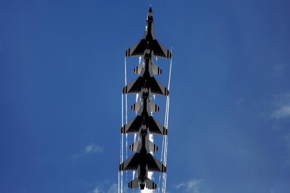 Free Image of Group of Fighter Jets Flying Through Blue Sky 