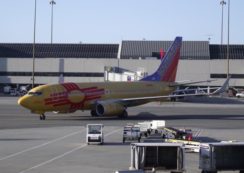 Free Image of Large Airliner Parked on Airport Tarmac 