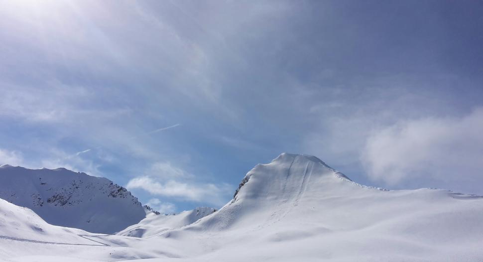 Free Image of Person Skiing Down Snow Covered Mountain 